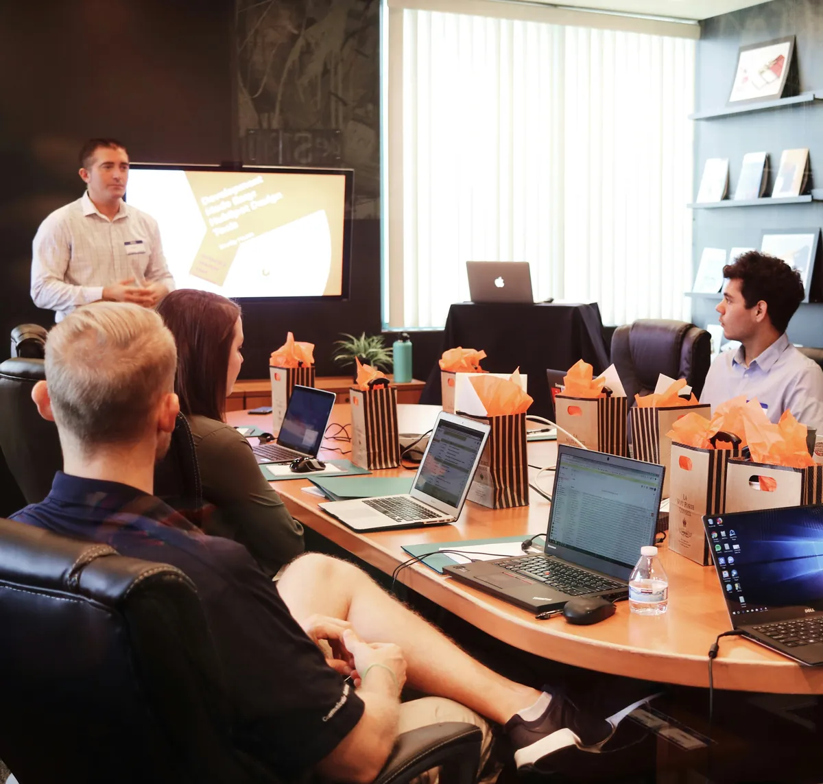 Team meeting in an office with a presenter at the front
